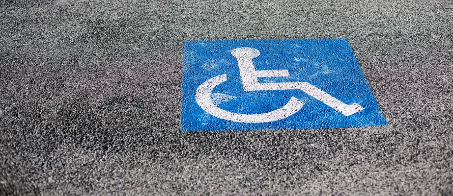 handicapped-parking-spot-blue-square-on-asphalt-4CVL3ZP.jpg